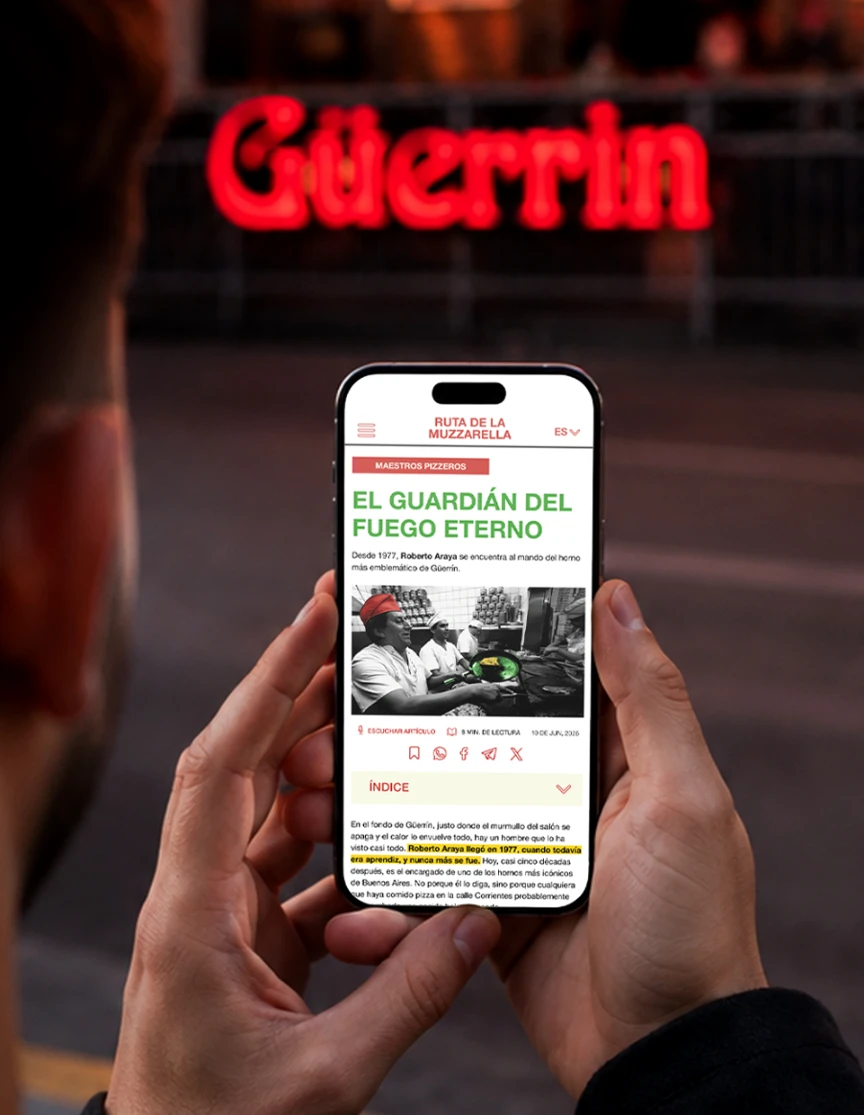 Mockup del suplemento Guerrin visto en un celular, con la fachada del local Guerrin al fondo.